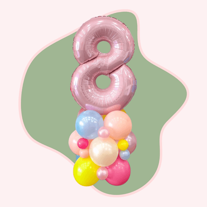 Pink number 8 balloon with colorful smaller balloons on a green and white background