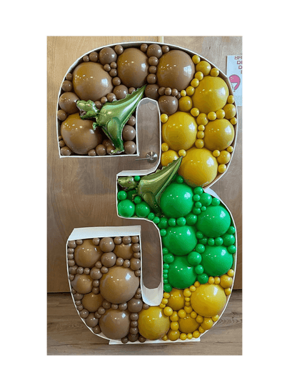 Decorative number '3' made of balloons on a wooden surface